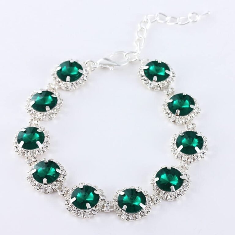 Silver bracelet with emerald green stones surrounded by small clear crystals
